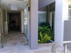 Pond feautre with plants and Koi at entrance into executive apartments